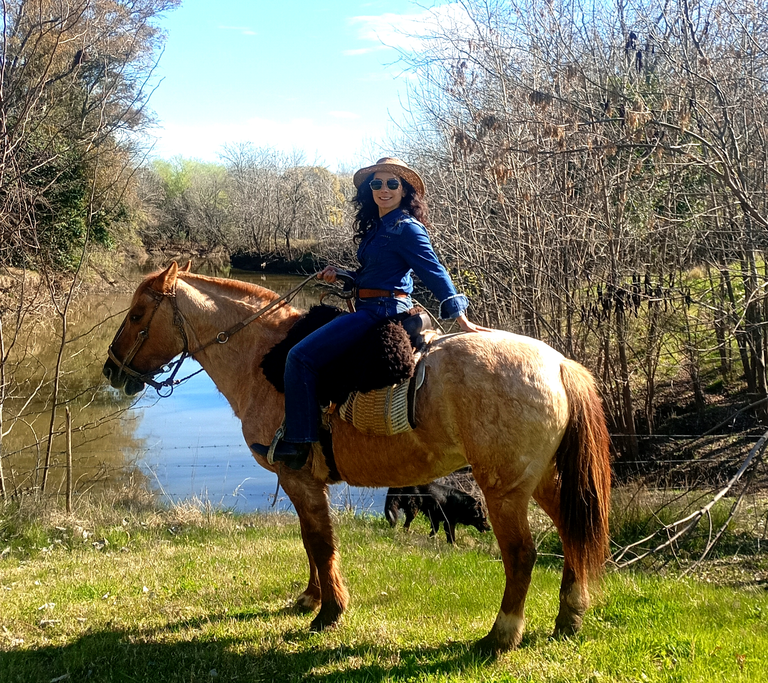 Dimitra horseback riding near the river